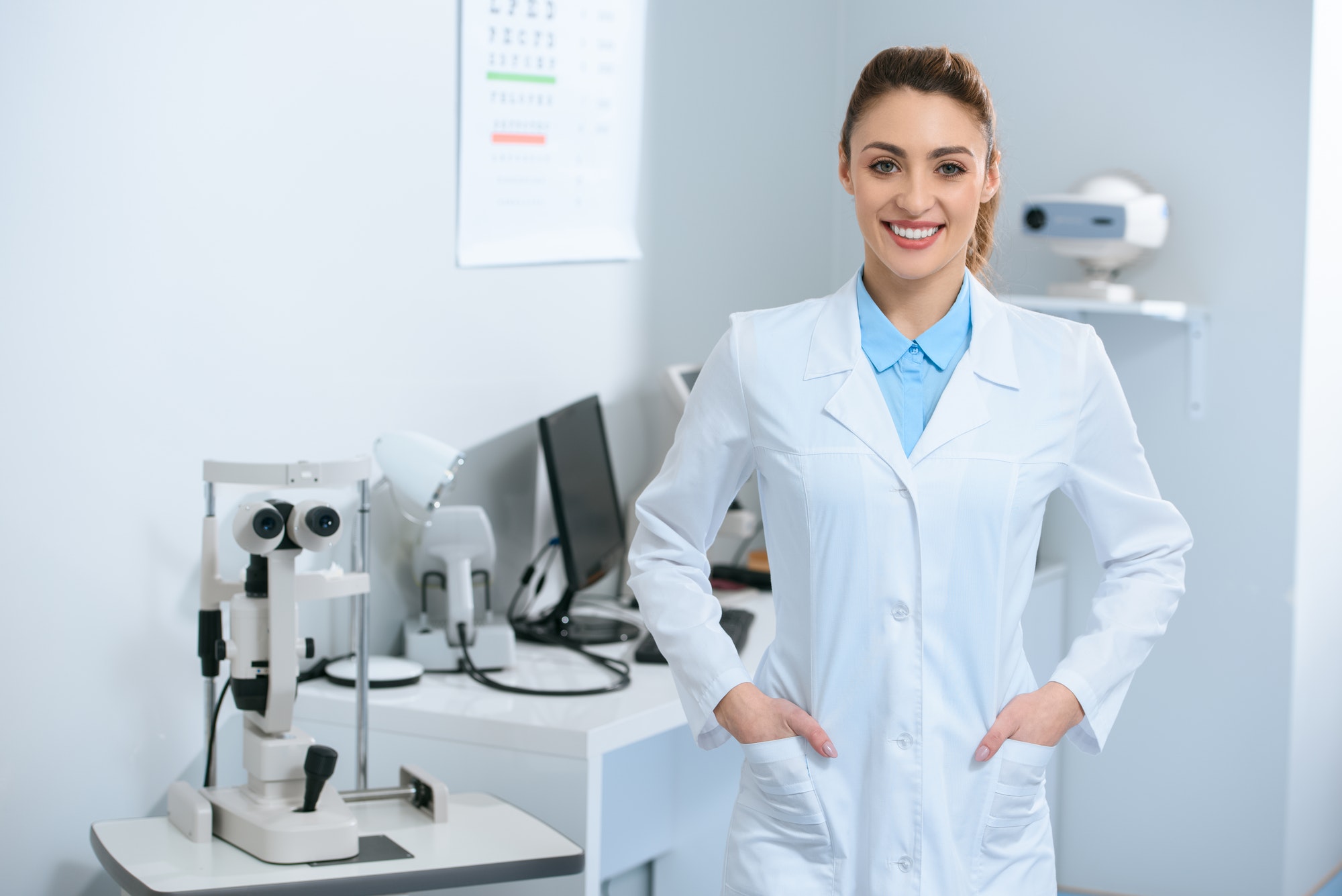 smiling female optometrist posing in optical clinic